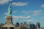 The Statue of Liberty carrying its torch high above the skyscrapers of New York
