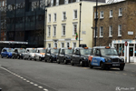 One behind the other waiting for customers, the drivers have an amazing memory of London's streets
